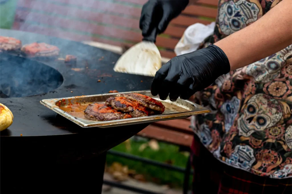 chef-preparing-burgers-at-the-barbecue-outdoors-2025-01-29-03-54-52-utc